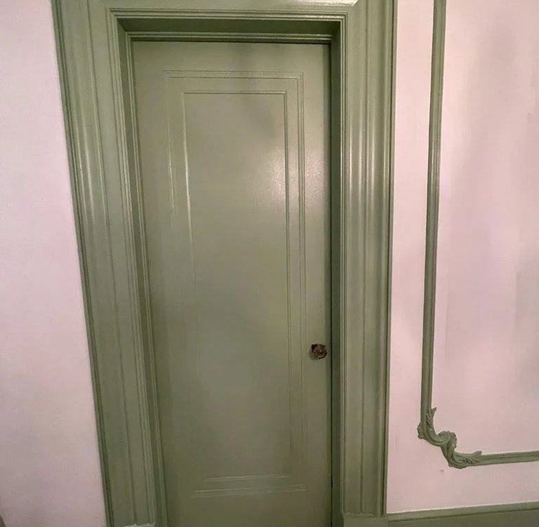 Finished green door, trim, and decorative wall detail painted by ColorMind2